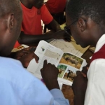 Student teacher reads to visually-impaired student about cape buffalos