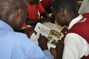 Student teacher reads to visually-impaired student about cape buffalos