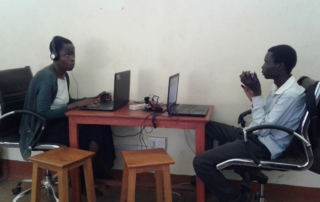 Computer teachers Elizabeth and Jasper prepare for lessons at Oysters & Pearls Uganda office in Gulu.