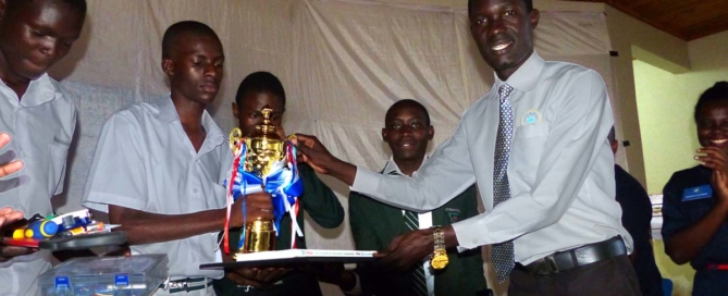 Students of Kiira College Butiiki receive their trophy aftr winning the National Science & Technology Challenge at Gulu University