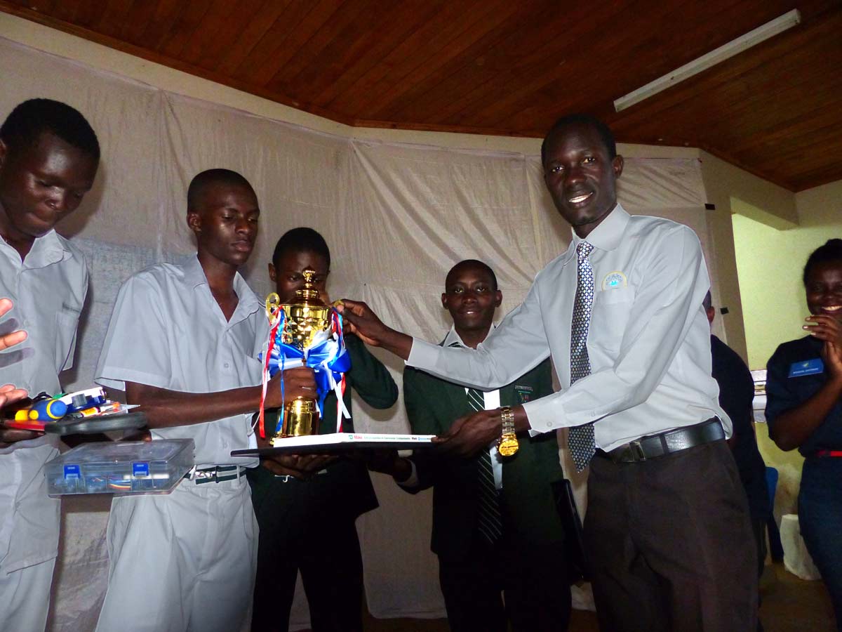 Students of Kiira College Butiiki receive their trophy aftr winning the National Science & Technology Challenge at Gulu University