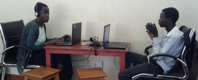 Computer teachers Elizabeth and Jasper prepare for lessons at Oysters & Pearls Uganda office in Gulu.